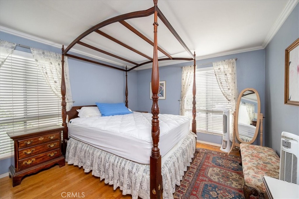 330 South Mentor Avenue, Unit 202 Pasadena, CA 91106 - Photo 11 of 16 a bedroom with bed and wooden floor