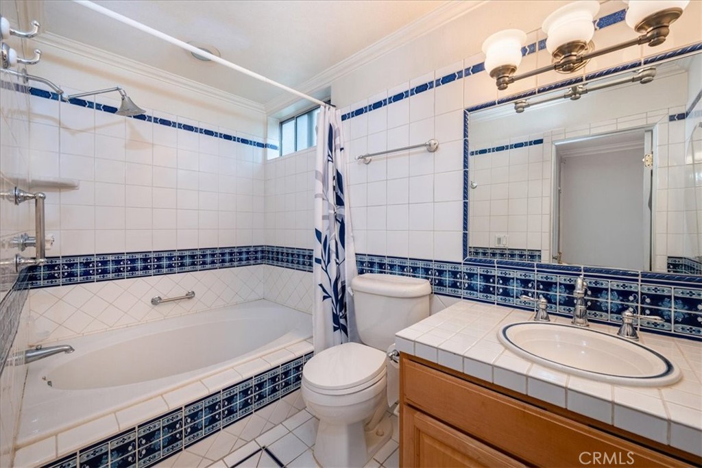 330 South Mentor Avenue, Unit 202 Pasadena, CA 91106 - Photo 12 of 16 a bathroom with a sink a toilet and a mirror