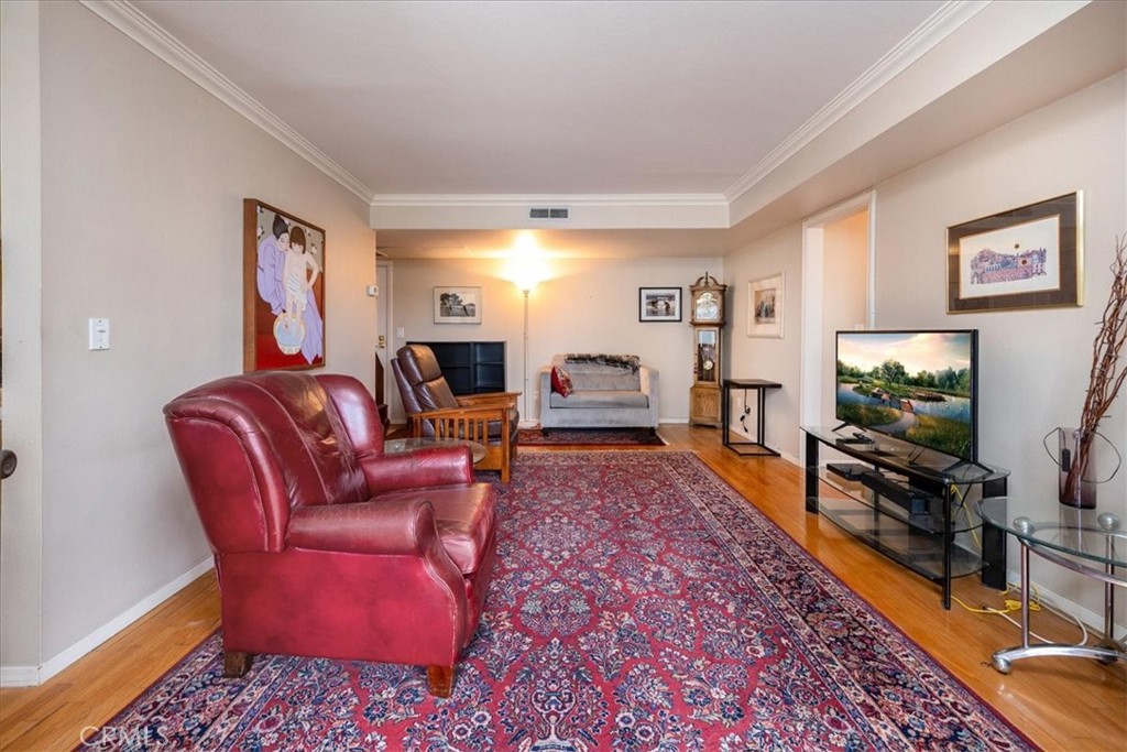330 South Mentor Avenue, Unit 202 Pasadena, CA 91106 - Photo 5 of 16 a living room with furniture and a flat screen tv