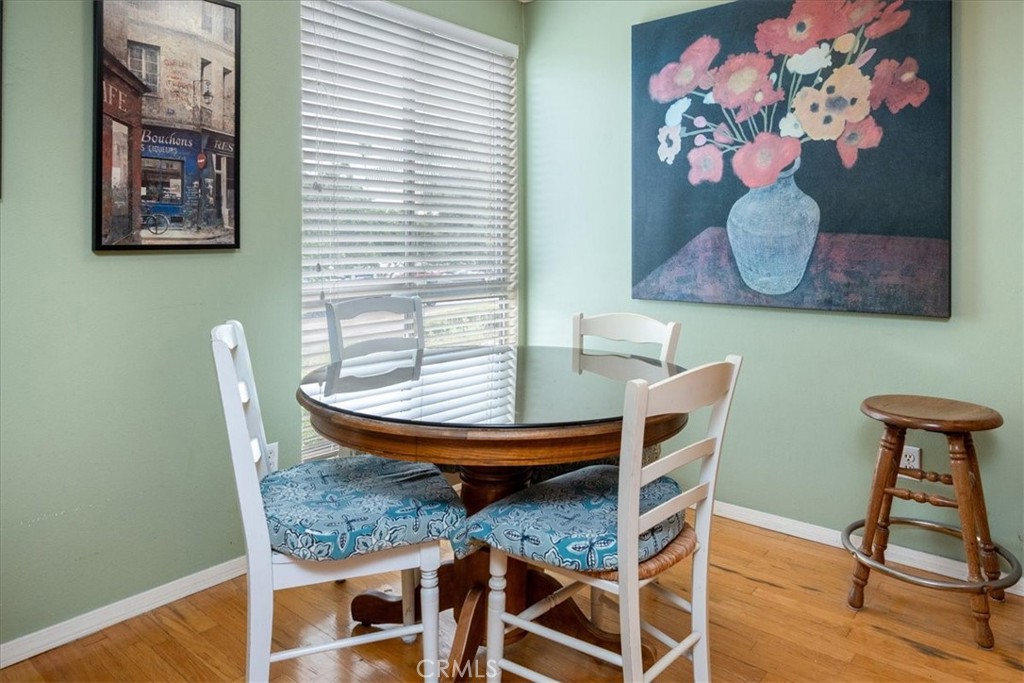 330 South Mentor Avenue, Unit 202 Pasadena, CA 91106 - Photo 8 of 16 a view of a dining room with furniture and wooden floor