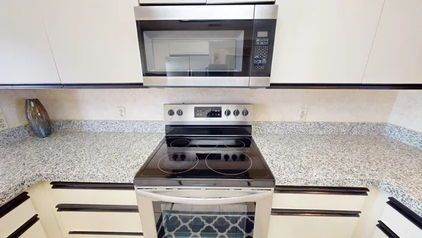 a white stove top oven sitting inside of a kitchen