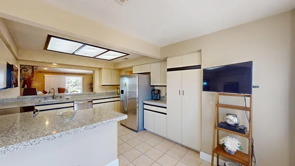 a kitchen with stainless steel appliances granite countertop a refrigerator and a sink