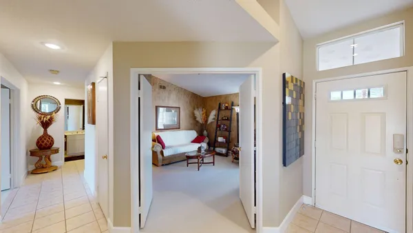 a view of a hallway with living room and furniture