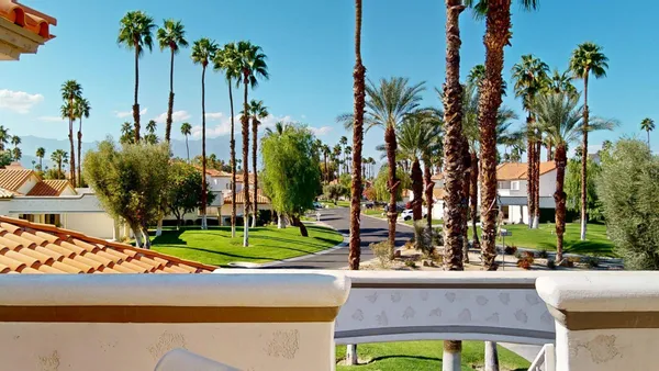 a view of a street with palm trees