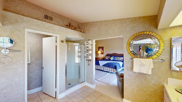 a bathroom with a sink a toilet and mirror