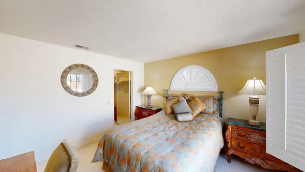 a bedroom with a bed and a chandelier