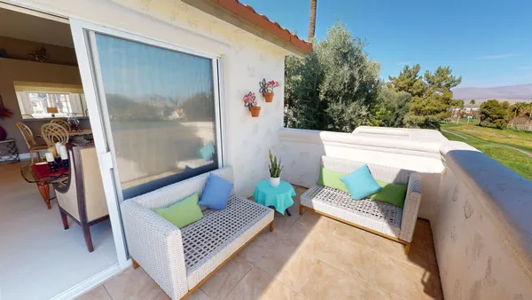 a view of a balcony with chairs