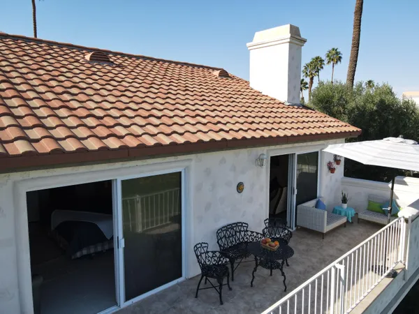 an aerial view of a house with swimming pool outdoor seating and yard
