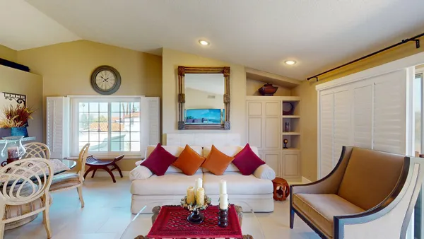 a living room with furniture a couch and a window