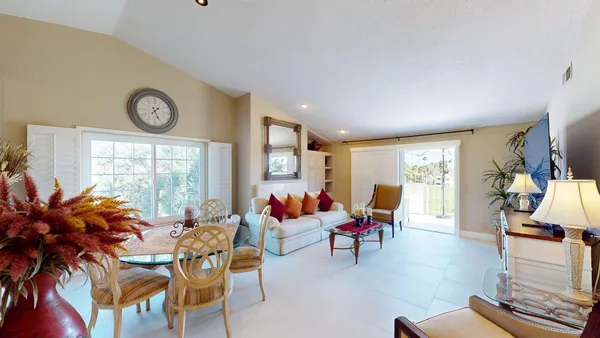 a living room filled with furniture and a large window