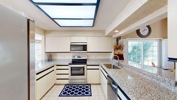 a kitchen with stainless steel appliances granite countertop a stove and a sink