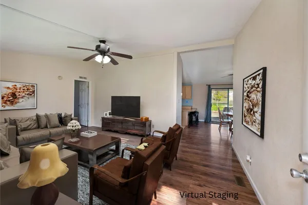 a dining room with furniture a window and wooden floor