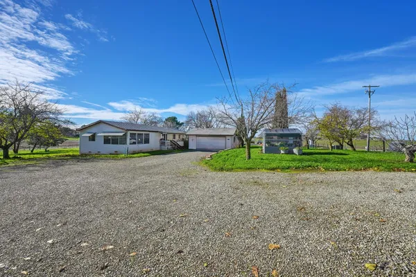a kitchen with stainless steel appliances granite countertop a refrigerator a sink dishwasher a stove and a oven with wooden floor