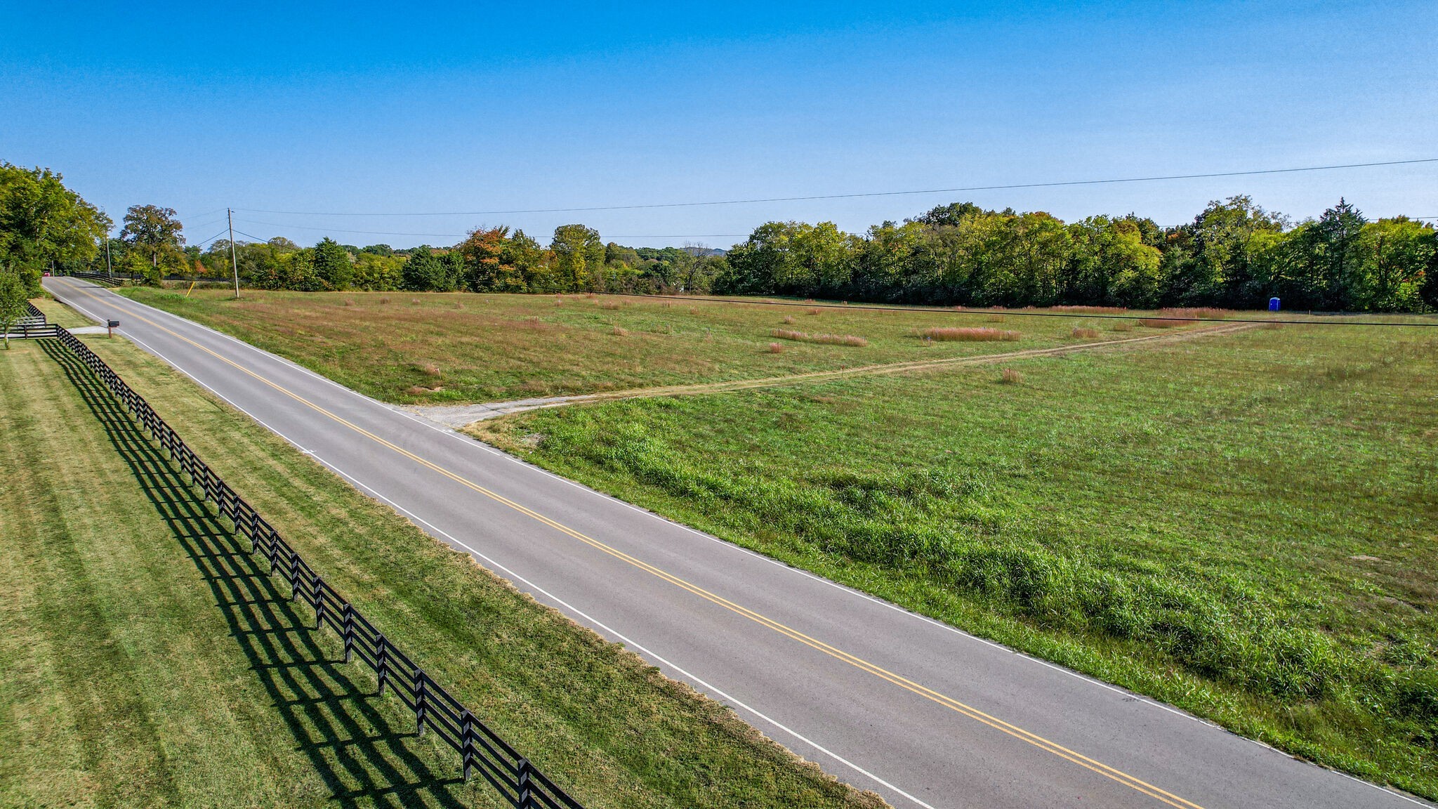 a view of a field with an ocean view