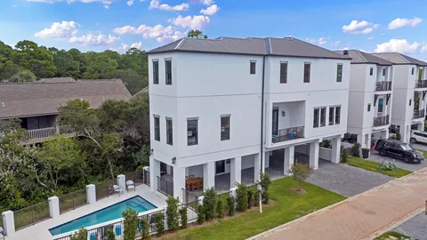 a view of a big house with a yard and plants