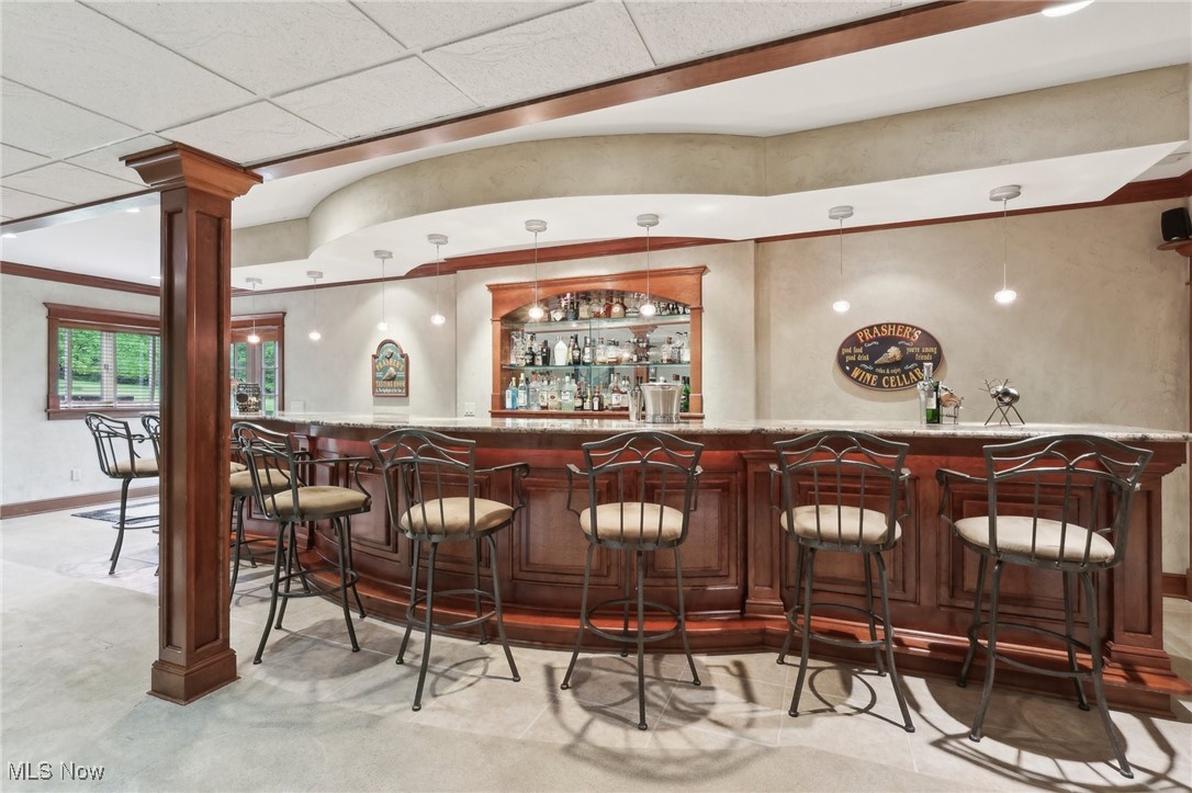 1491 Ridgewood Road Wadsworth, OH 44281 - Photo 18 of 36 Indoor bar with decorative columns, hanging light fixtures, and room for 8!