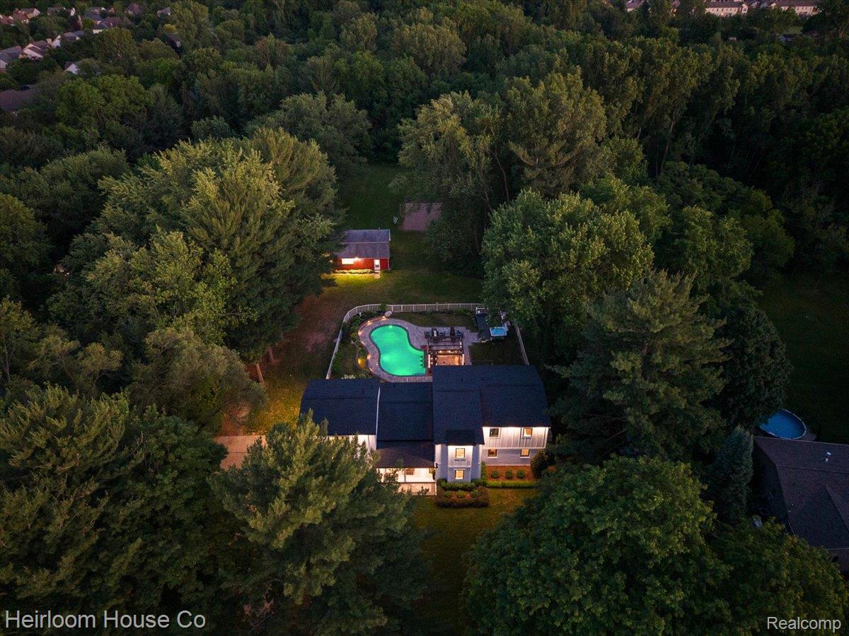 49001 Hanford Road Canton, MI 48187 - Photo 68 of 98 Secluded property featuring a main residence, a detached shed, and a fenced-in swimming pool