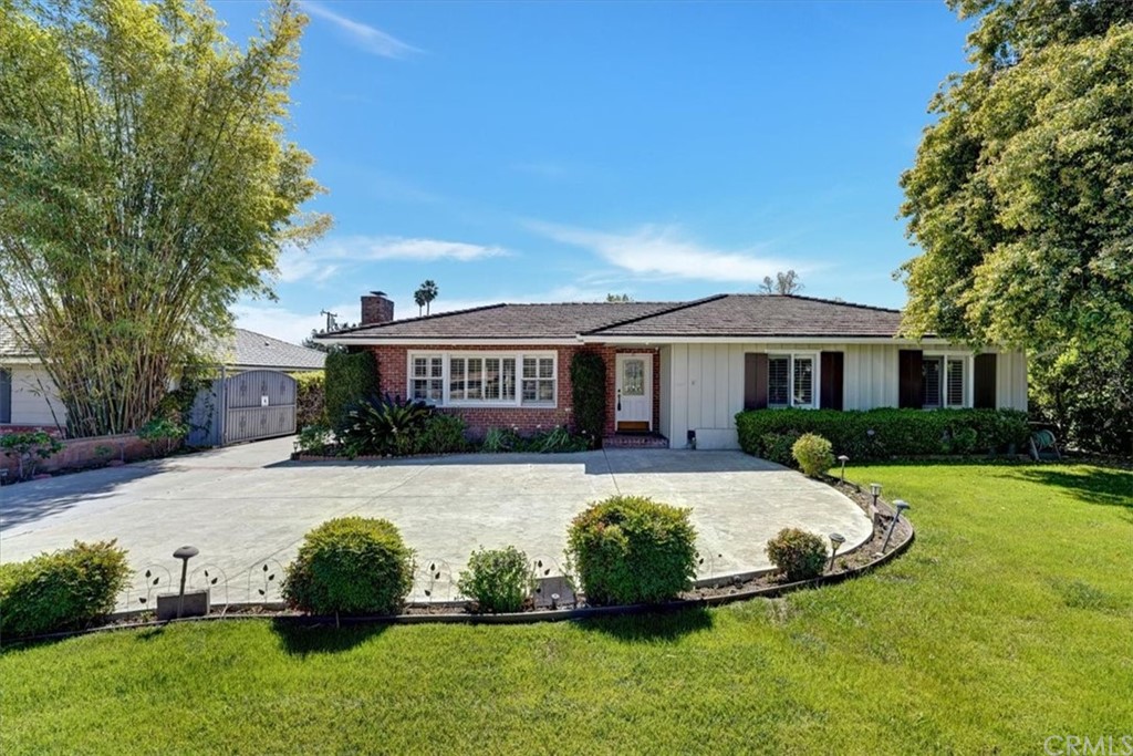 a front view of a house with a garden