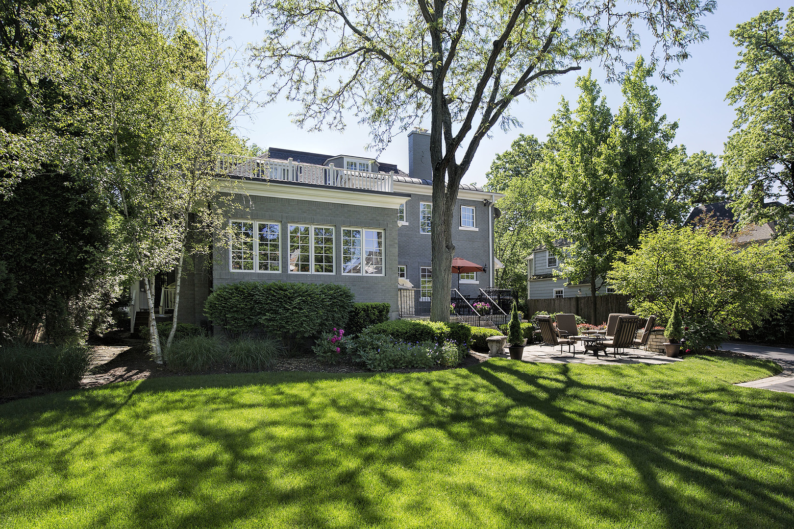 268 Ridge Avenue Winnetka, IL 60093 - Photo 24 of 26 a view of a chair and tables in the back yard of the house