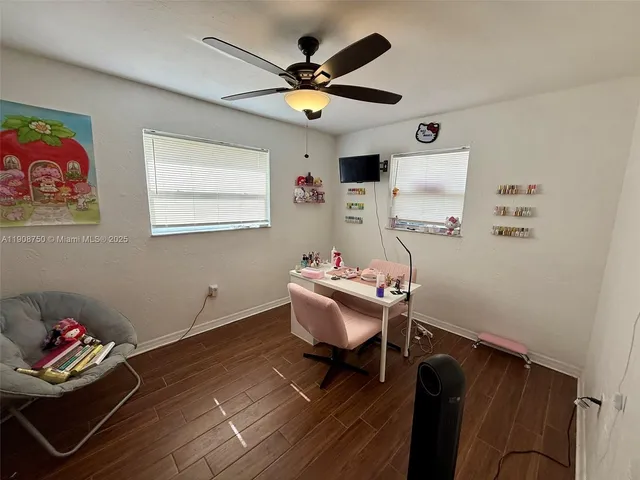 a living room with furniture and a ceiling fan