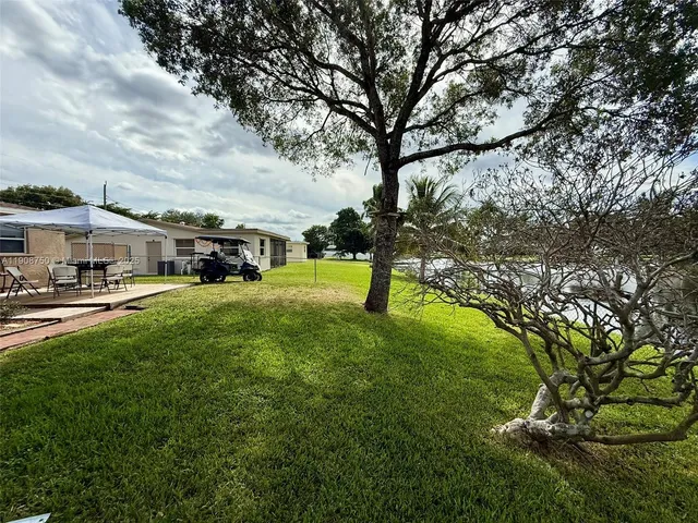 a view of yard with swimming pool and trees