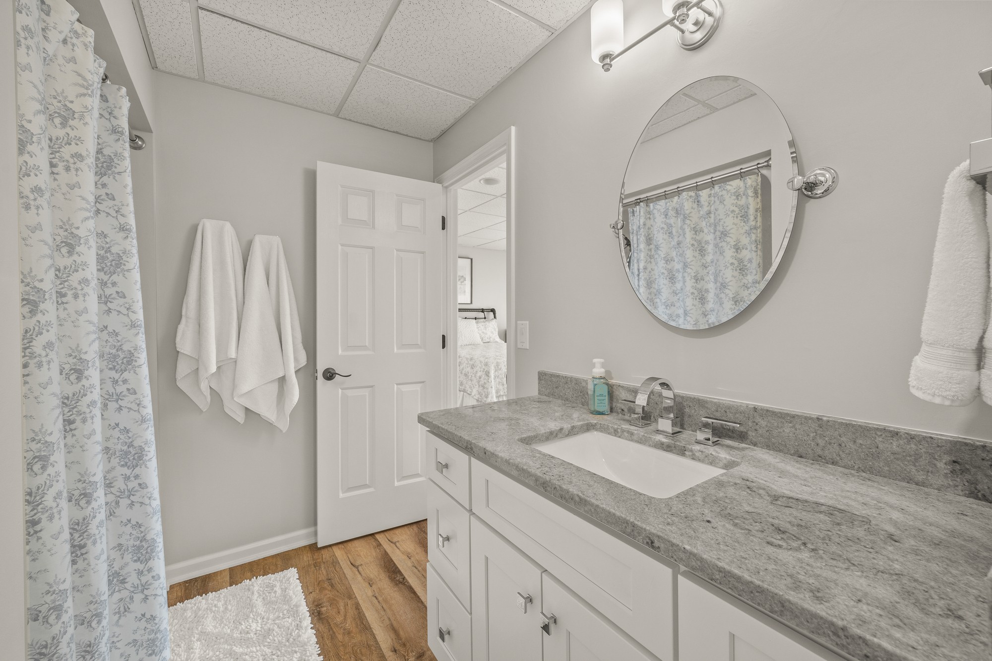998 Highland Trail Sparta, TN 38583 - Photo 23 of 43 a bathroom with a granite countertop sink a mirror and a shower