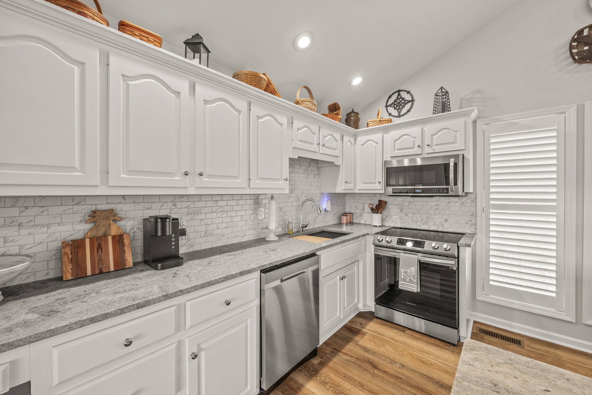 998 Highland Trail Sparta, TN 38583 - Photo 7 of 43 a kitchen with stainless steel appliances granite countertop a sink a stove and cabinets