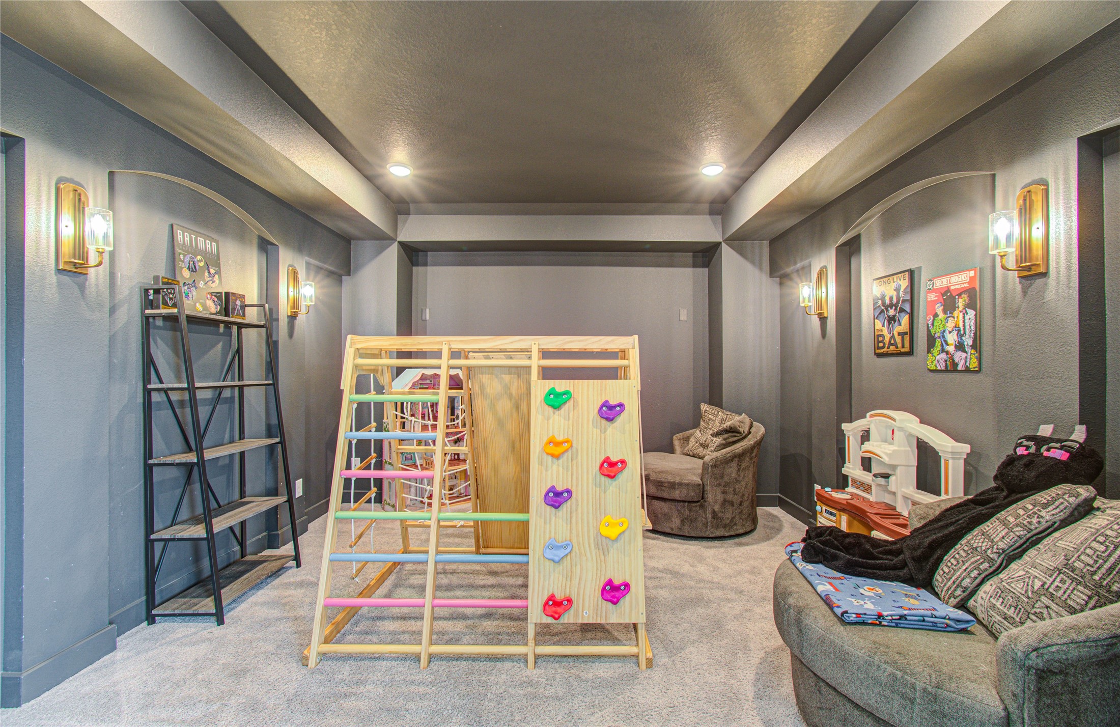 4211 Limestone Terrace Manvel, TX 77578 - Photo 22 of 33 This cozy home theater room features soft gray walls, recessed lighting, and playful decor. It includes a kids' play area with climbing equipment and comfortable seating, perfect for family entertainment.