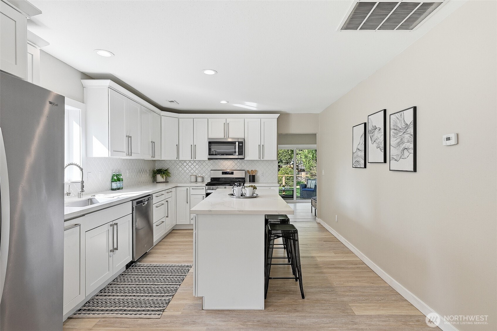 18824 80th Avenue West Edmonds, WA 98026 - Photo 8 of 35 a kitchen with white cabinets and stainless steel appliances