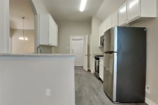 a kitchen with a refrigerator and a sink