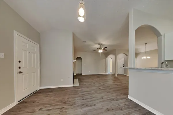 a view of a room with wooden floor and staircase
