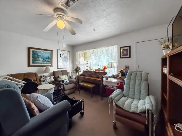 a living room with furniture and a large window