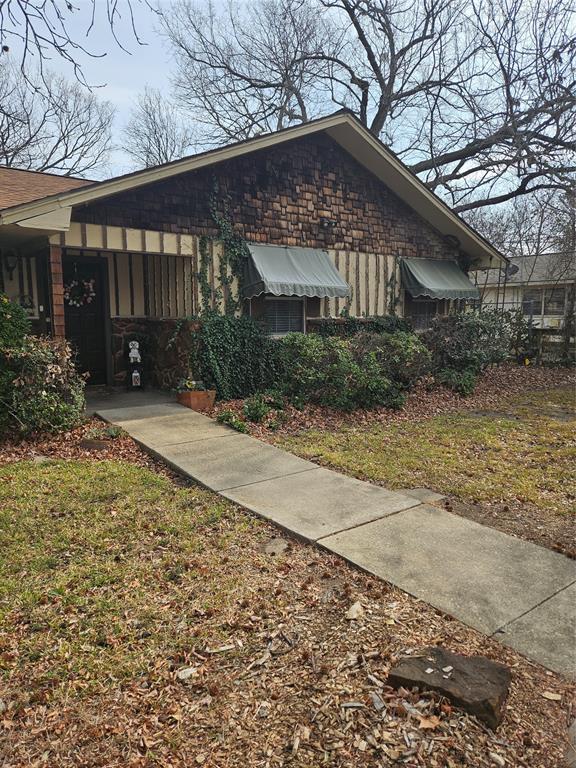 3200 Donna Road Denton, TX 76207 - Photo 35 of 40 a front view of a house with a yard and potted plants