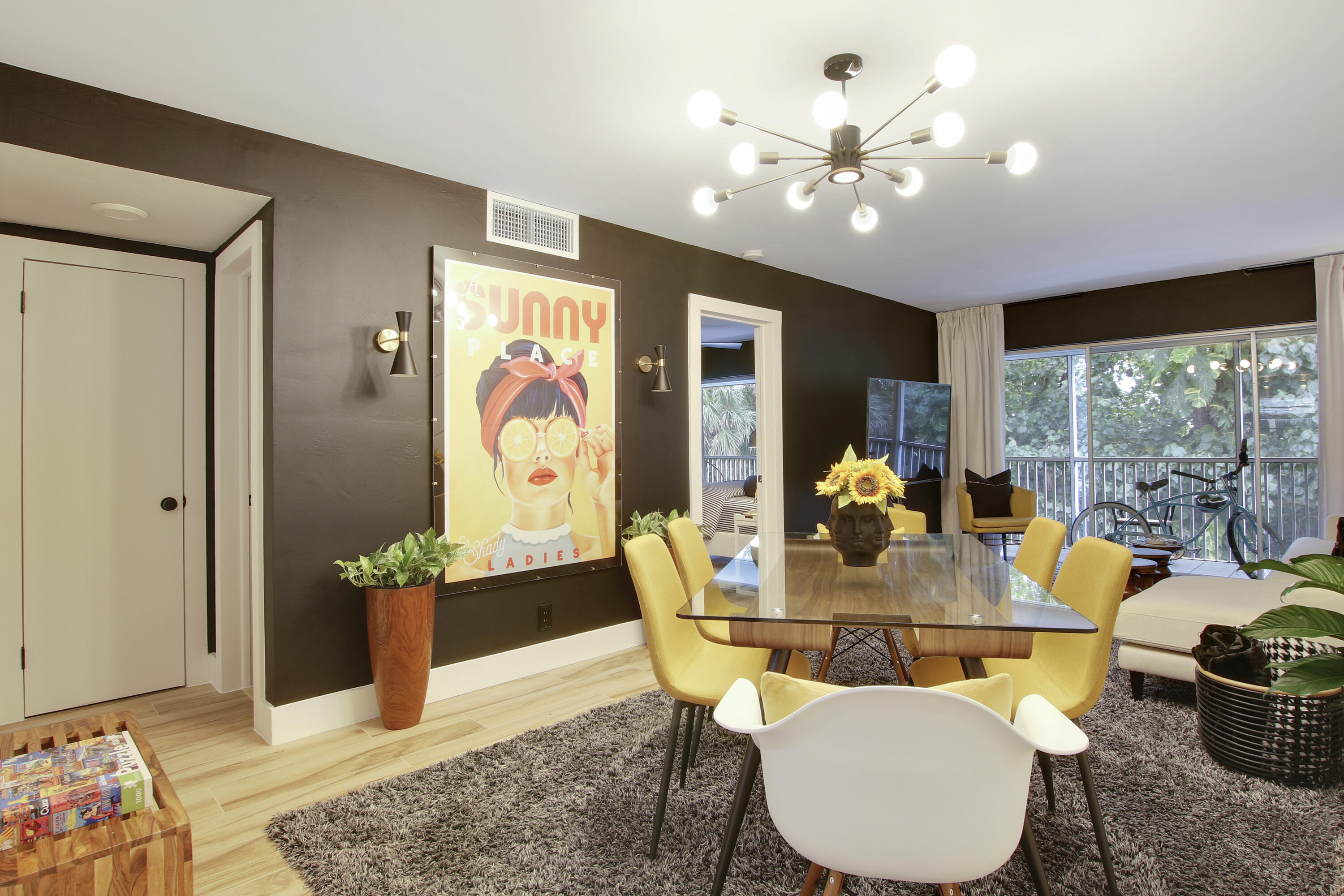 50 Celestial Way, Unit 310 Juno Beach, FL 33408 - Photo 1 of 26 a dining room with furniture potted plants and wooden floor