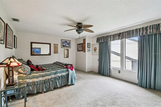 a living room with furniture and a ceiling fan