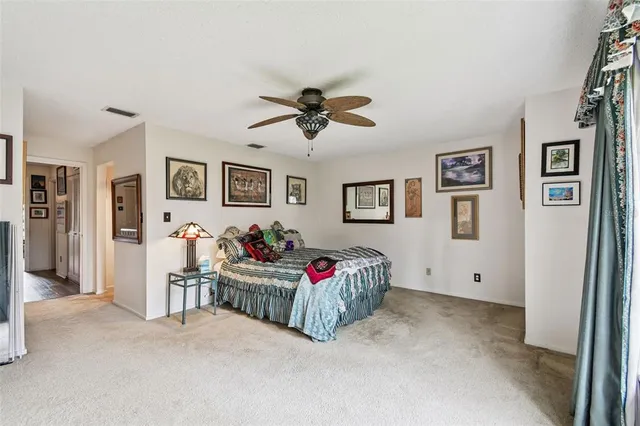 a living room with furniture and a ceiling fan