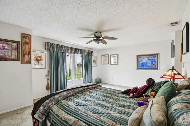 a bed sitting in a bedroom next to a window