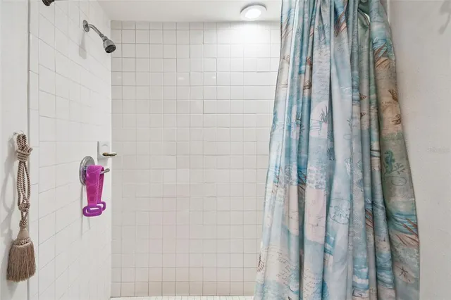 a bathroom with a shower and a shower