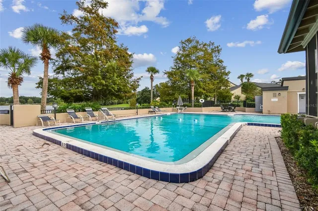 a view of a swimming pool with a yard