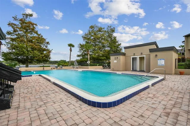 a view of a backyard with swimming pool
