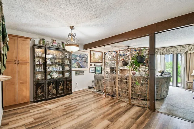 a view of a livingroom with wooden floor and furniture