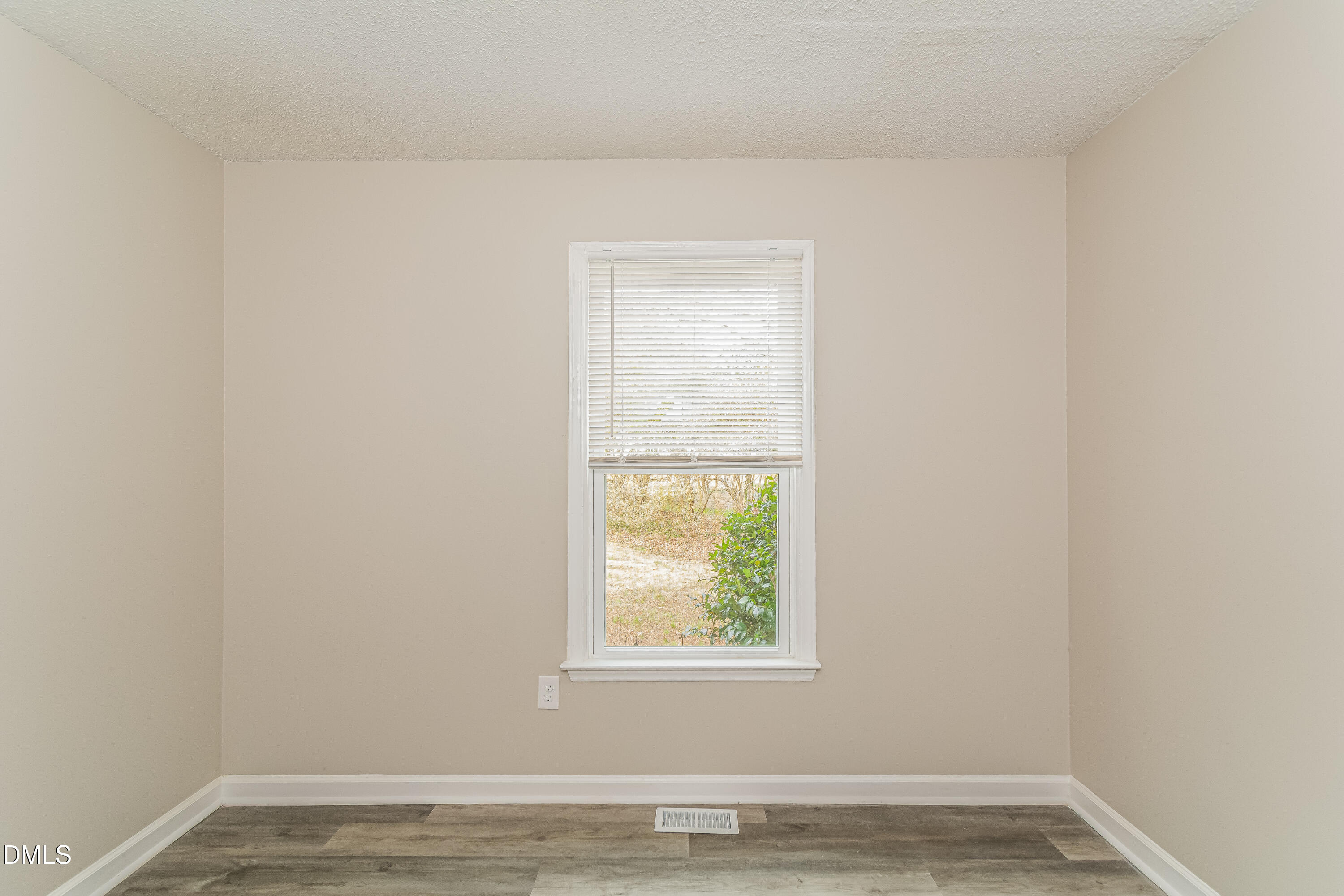 617 Bartlett Road Fuquay-Varina, NC 27526 - Photo 12 of 16 an empty room with wooden floor and windows