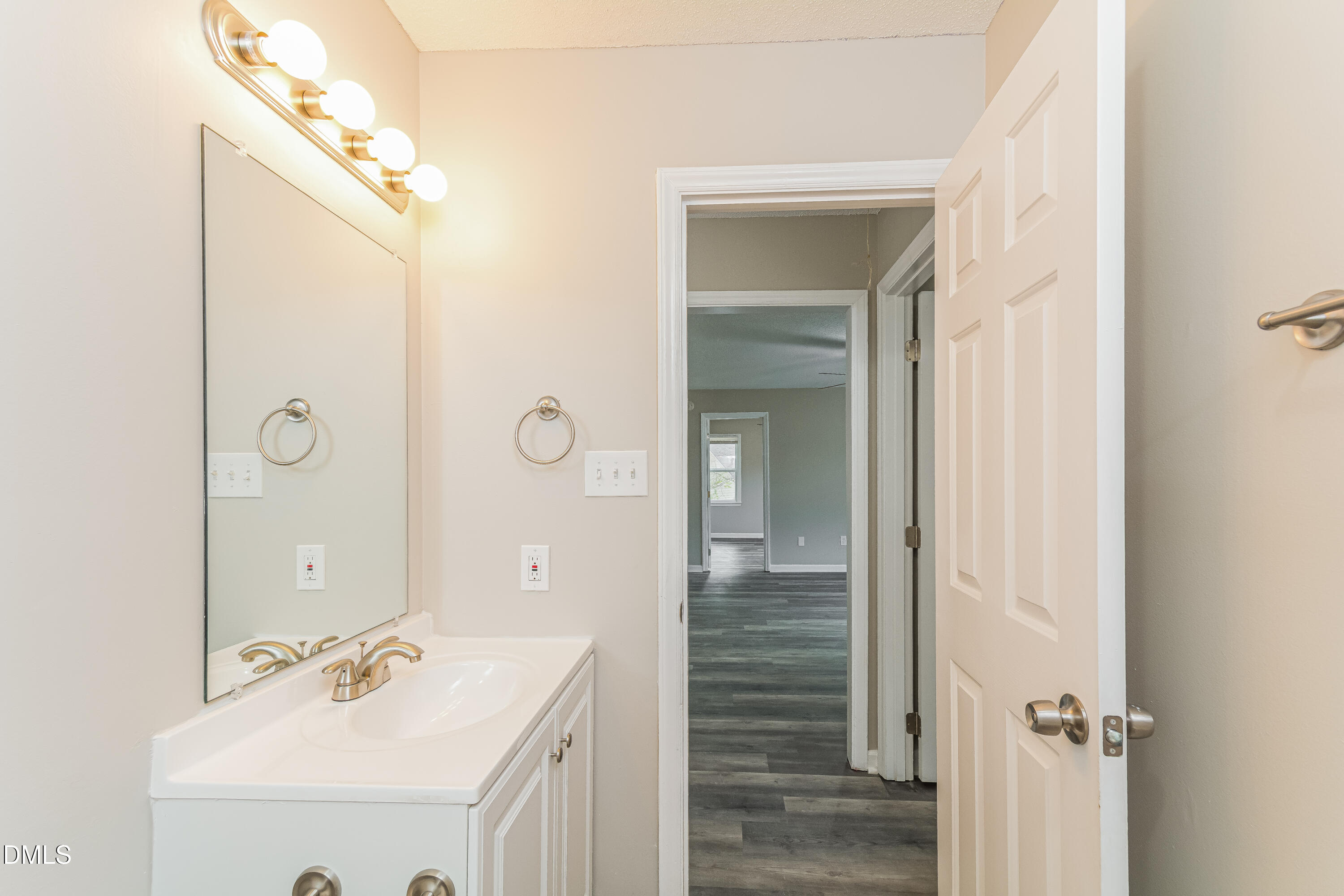 617 Bartlett Road Fuquay-Varina, NC 27526 - Photo 14 of 16 a bathroom with a sink a mirror and shower