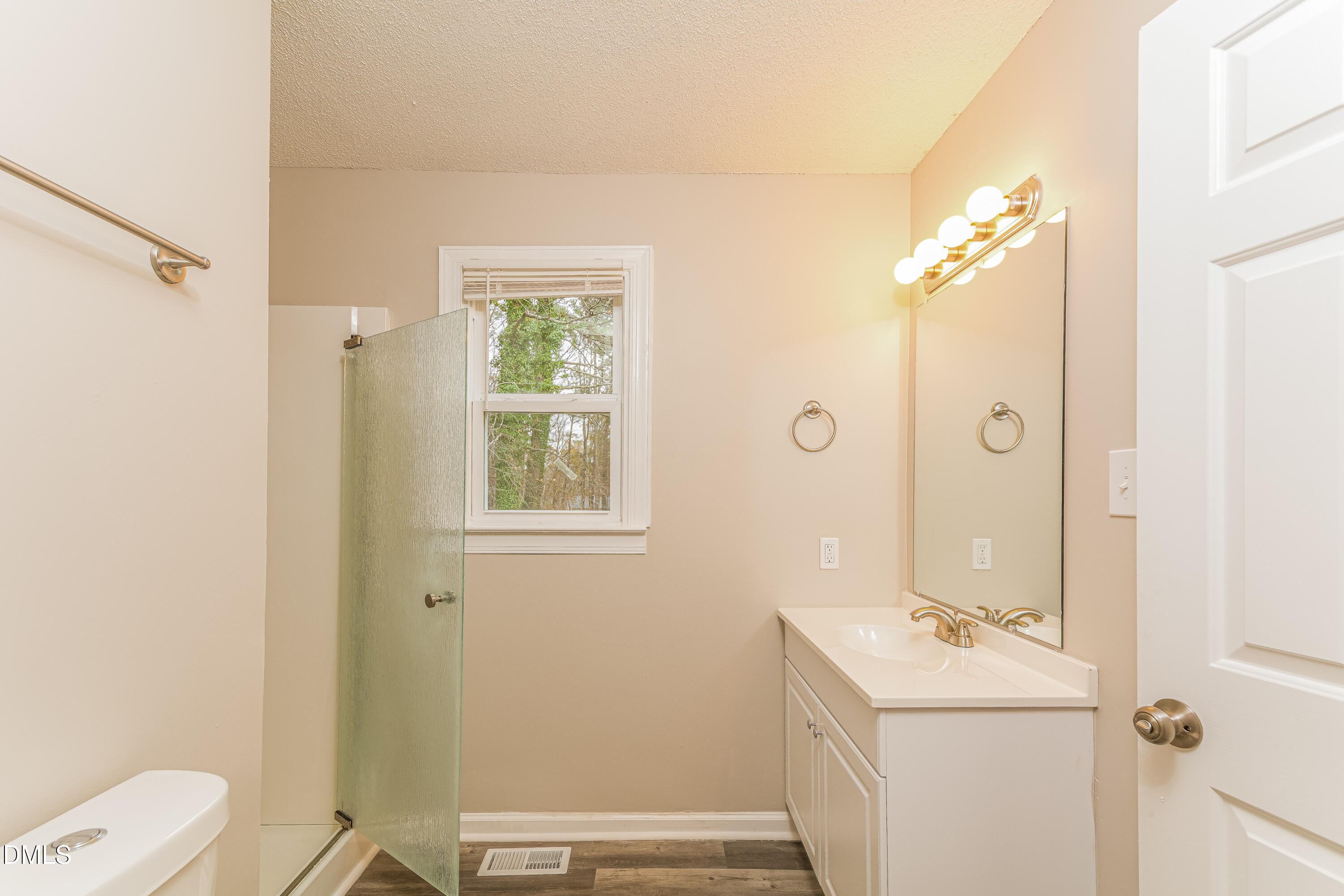 617 Bartlett Road Fuquay-Varina, NC 27526 - Photo 15 of 16 a bathroom with a sink a toilet and shower