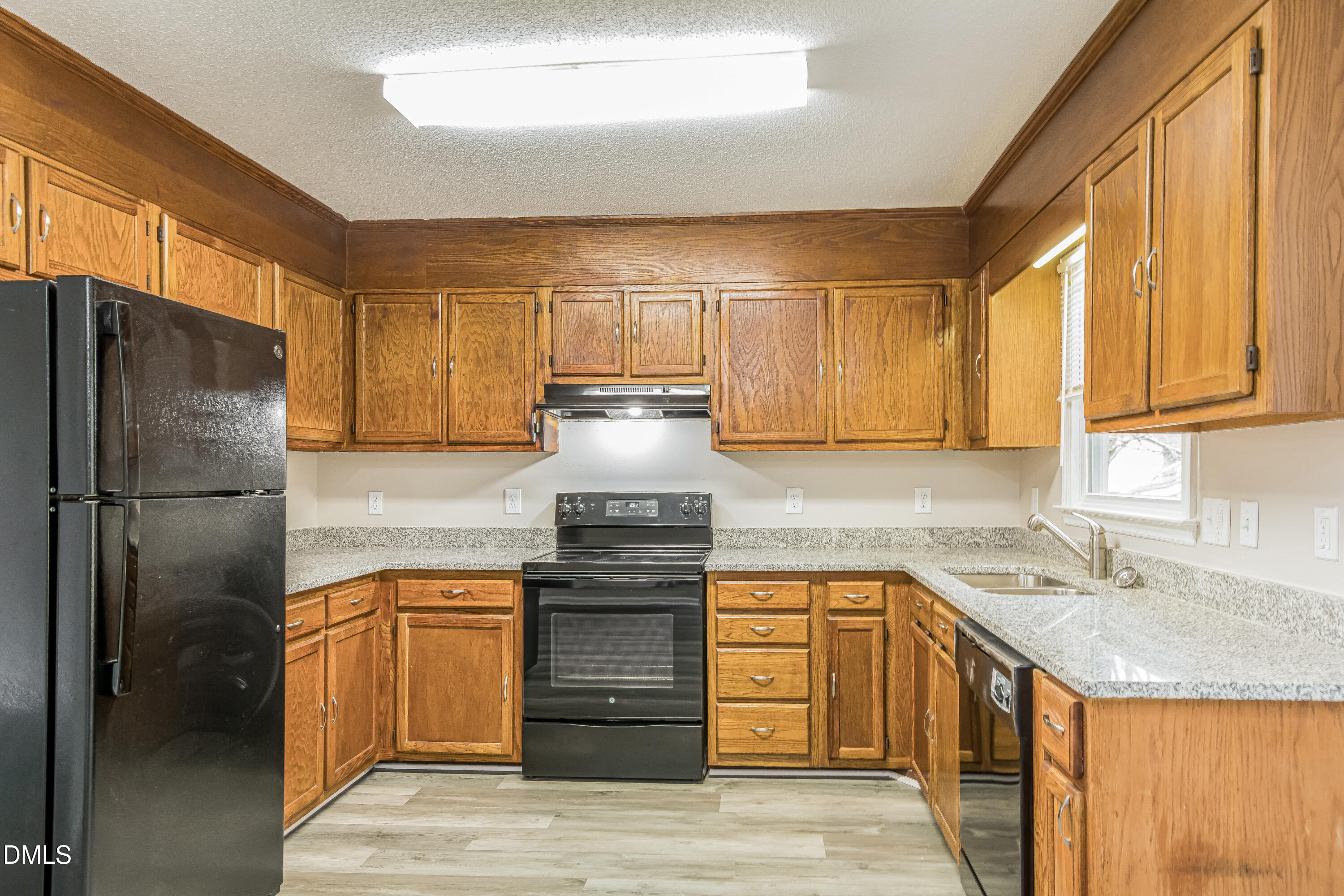 617 Bartlett Road Fuquay-Varina, NC 27526 - Photo 5 of 16 a kitchen with stainless steel appliances granite countertop a sink stove and refrigerator