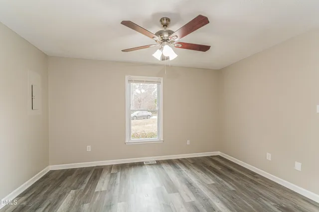 wooden floor in an empty room with a window