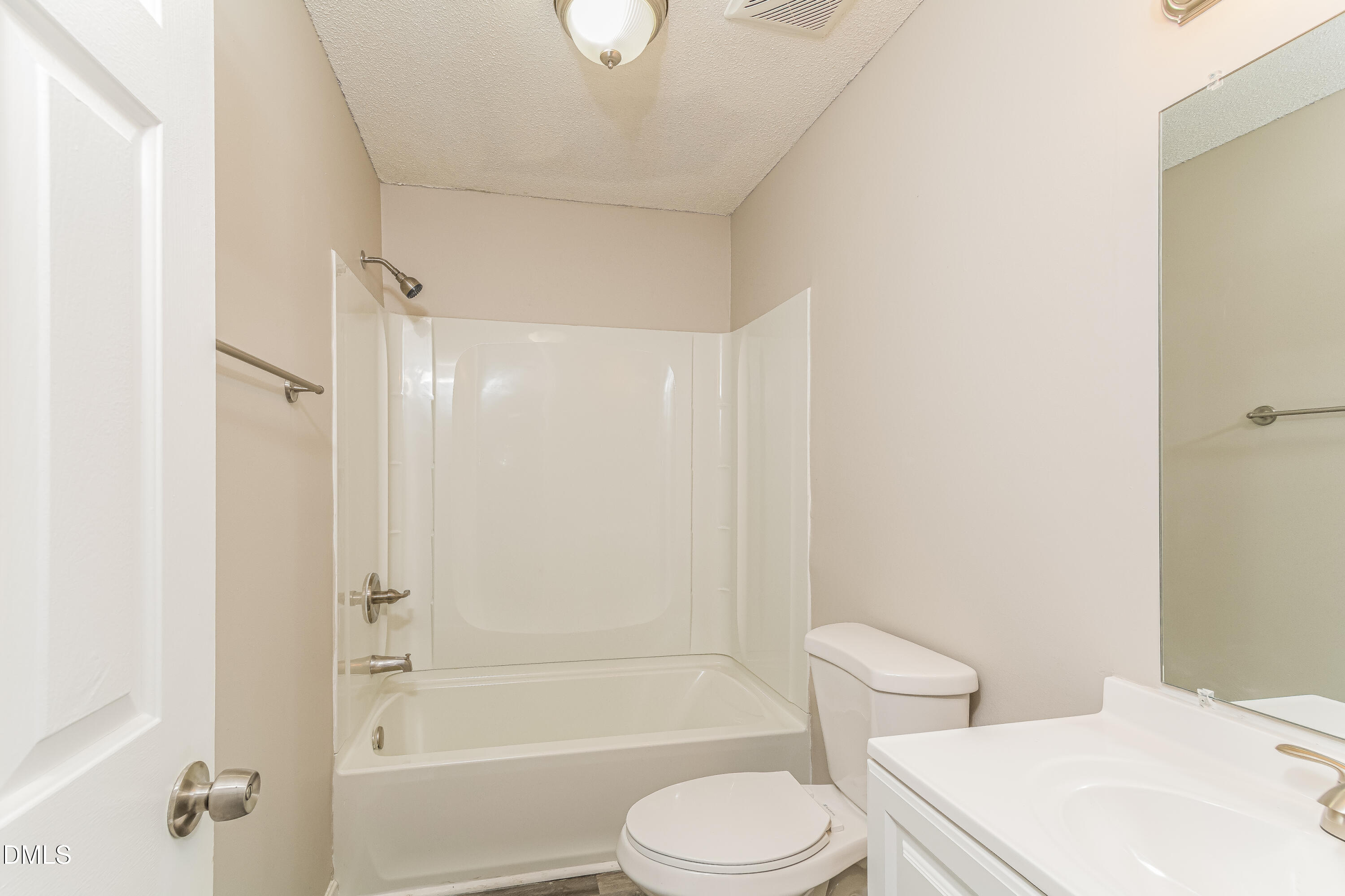 617 Bartlett Road Fuquay-Varina, NC 27526 - Photo 8 of 16 a bathroom with a toilet a sink and a bathtub