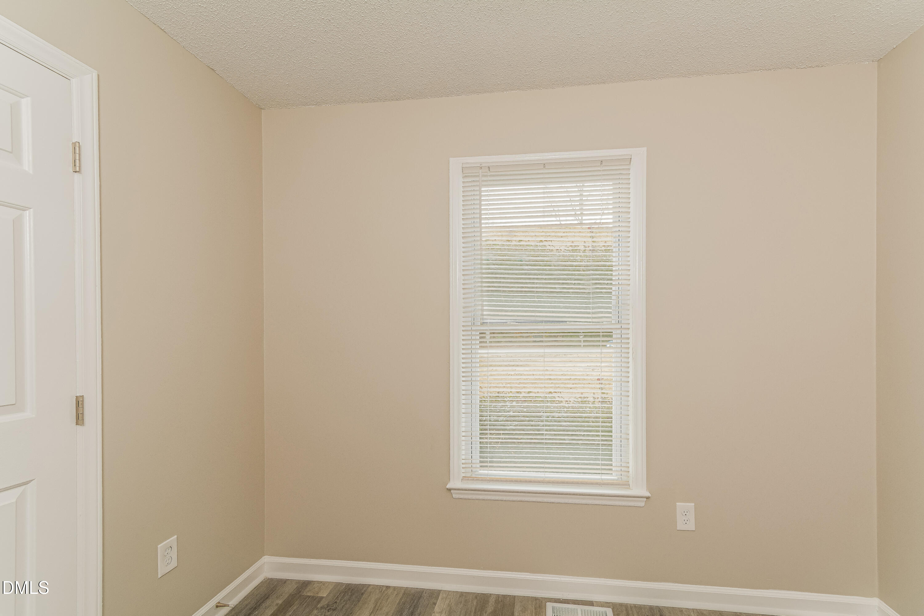 617 Bartlett Road Fuquay-Varina, NC 27526 - Photo 10 of 16 a view of an empty room with a window