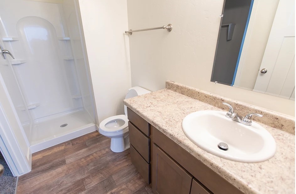 21155 Gosling Road, Unit 47B Spring, TX 77388 - Photo 14 of 29 a bathroom with a granite countertop sink a toilet a mirror and shower
