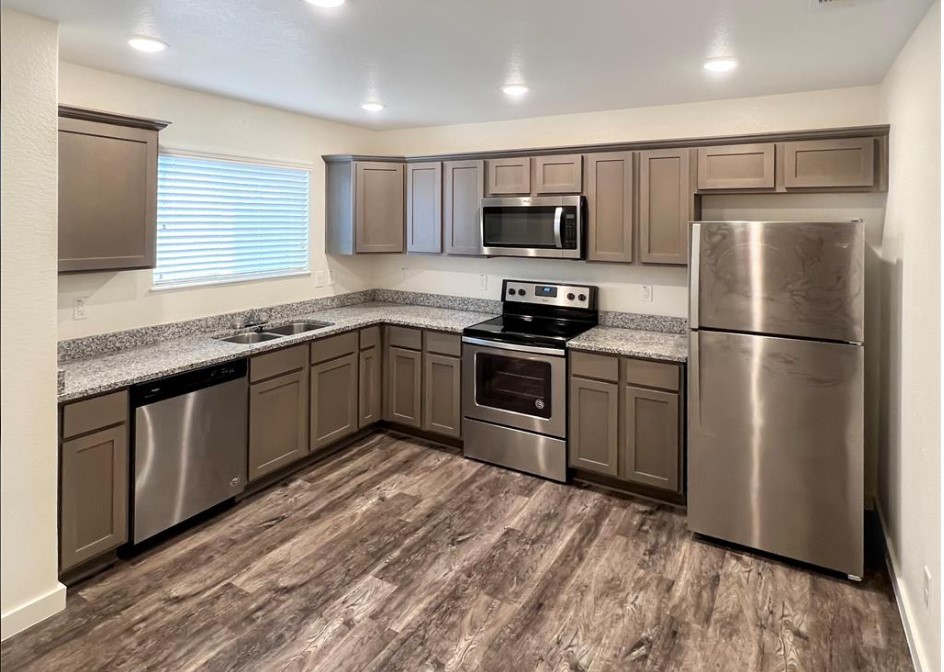 21155 Gosling Road, Unit 47B Spring, TX 77388 - Photo 6 of 29 a kitchen with stainless steel appliances granite countertop a stove a sink dishwasher a refrigerator and a microwave